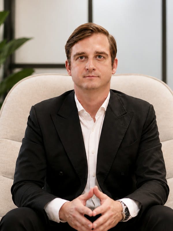 Tomasz Felpel, founder and CEO of Value Alpha, seated in an armchair with his hands together.